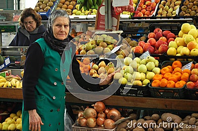 Elderly woman at a fruit stall in Portugal Editorial Stock Photo