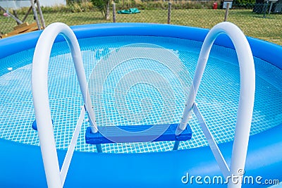 Typical inflatable swimming pool in the garden Stock Photo