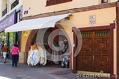 A typical ladies fashion shop with street displays and inviting archway entrance in the Spanish island of Teneriffe in the Canarys Editorial Stock Photo