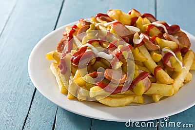 Typical Latin America Salchipapa. Sausages with fries, ketchup,mayo and mustard Stock Photo