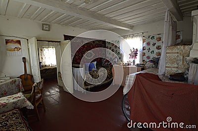 Typical living room in the Ukrainian rural house clay stove beds carpets chairs table. 2021. Teterivske village, Kyiv Editorial Stock Photo