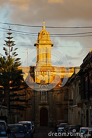 Typical maltese church in sunset hidden between small historical streets Editorial Stock Photo
