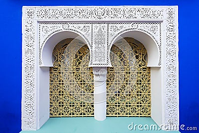 Typical moroccan window with blue wall Stock Photo