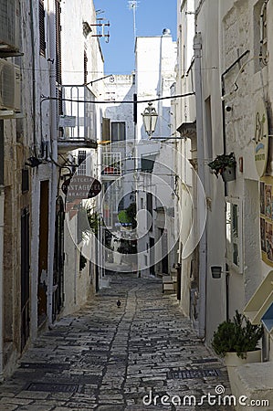 Typical narrow little street with a lots of stairs in Ostuni, La Citta Bianca. Ostuni. Puglia, Italy Editorial Stock Photo