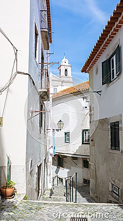 Typical narrow winding street in the Alfama district, Lisbon, Portugal Stock Photo