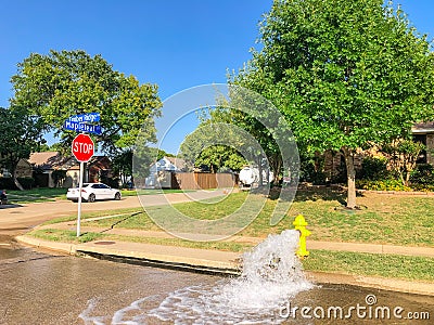 Typical neighborhood area with stop sign near Dallas, Texas, America with open yellow fire hydrant Stock Photo