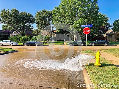 Typical neighborhood area with stop sign near Dallas, Texas, America with open yellow fire hydrant Stock Photo