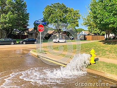 Typical neighborhood area with stop sign near Dallas, Texas, America with open yellow fire hydrant Stock Photo