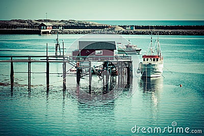 Typical Norwegian fishing village with traditional red rorbu hut Stock Photo