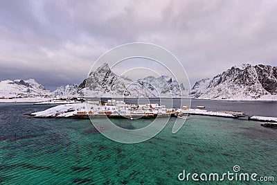 Typical Norwegian landscape. Beautiful view of scenic Lofoten Islands winter scenery with traditional yellow fisherman Rorbuer cab Stock Photo
