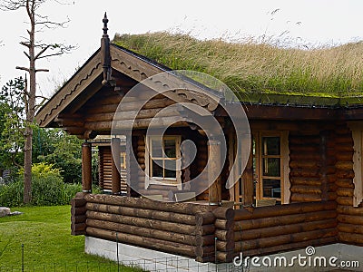 Typical Norwegian wooden mountain cabin log house with turf roof Stock Photo