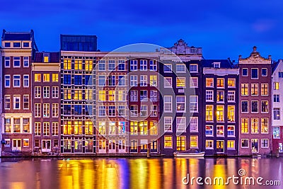 Typical old dutch houses over canal with reflections at twilight in Amsterdam, North Hilland, Netherlands. Amsterdam postcard Editorial Stock Photo