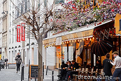 Typical Parisian cafe decorated with flowers in Paris, France Editorial Stock Photo