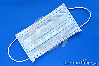Typical 3 ply surgical face mask with rubber ear straps. Stock Photo