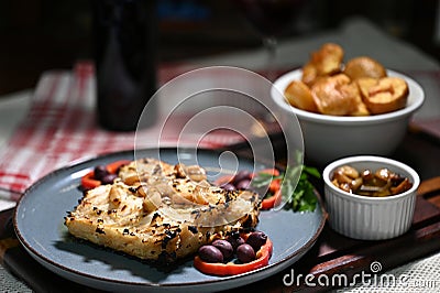 typical portuguese dish roasted codfish with onion garlic peppers and rustic babata lusitanian food Stock Photo