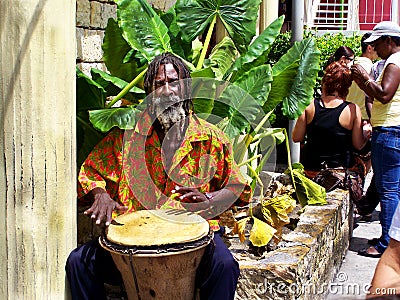 Typical sight in Antigua, a street musician with a lady doing breads Editorial Stock Photo