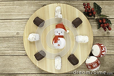 typical Spanish almond and almond and chocolate polvoron, mistletoe, Chritsmas balls and Santa clock Stock Photo