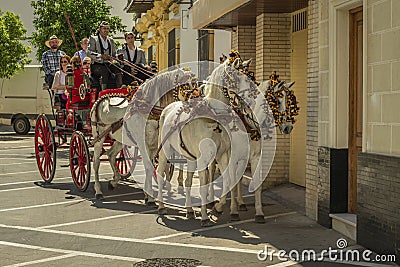 Typical Spanish coachmen ride tourists in a four-horse-drawn carriage in the streets of Jerez de la Frontera, Andalusia, Spain May Editorial Stock Photo