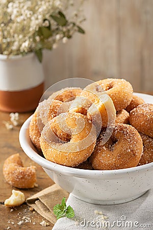 Typical spanish donuts, fried rosquillas with sugar for breakfast on rustic wooden table, traditional homemade anise donuts from Stock Photo