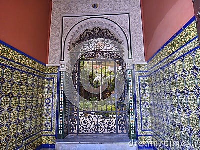typical spanish patio with wrought iron gate, tiles and flowers Editorial Stock Photo