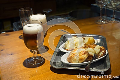 Typical tapa of beer and roasted potatoes in Spain Stock Photo