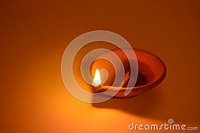 Typical traditional Indian earthen terra-cotta lamp. Stock Photo