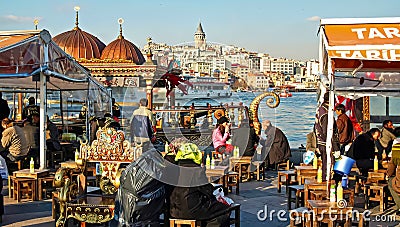 Typical turkish riverside cafes, skyline of galata district background in springtime Editorial Stock Photo