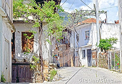 A typical Turkish village with a lady sitting on the door step Editorial Stock Photo