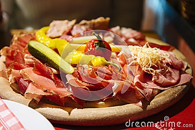 A typical tyrolean mixed cold platter served on a wooden board Stock Photo