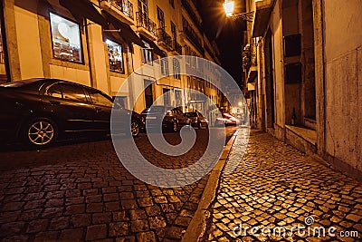 Typical urban night scene in the old part of Lisbon. View on Rua da Padaria street, near the Lisbon Cathedral Stock Photo