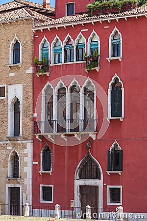Typical venetian building, red walls with white gothic windows Editorial Stock Photo