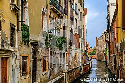Weathered building facade on a picturesque canal in Venice Italy Stock Photo