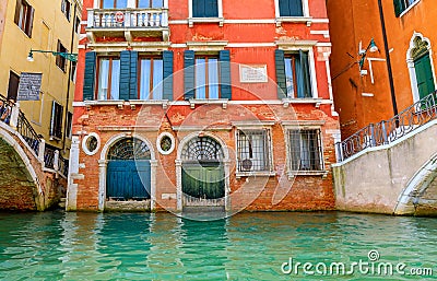 Weathered building facade on a picturesque canal in Venice Italy Editorial Stock Photo