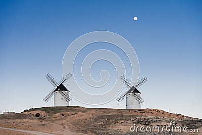 Typical windmill in with the moon at the background Stock Photo