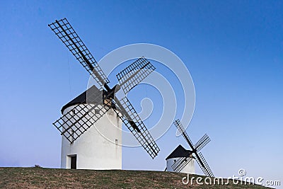 Typical windmill in with the moon at the background Stock Photo