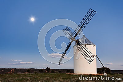 Typical windmill in with the moon at the background Stock Photo