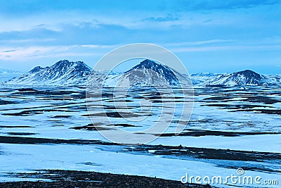 Typical winter landscape with snowy mountains in the background between Egilsstadir and Akureyri, Northeast of Iceland Stock Photo