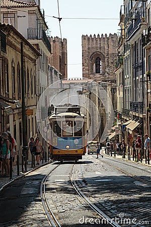 Typical Yellow Vintage Tram in Narrow Street of Lisbon, Portugal. Editorial Stock Photo