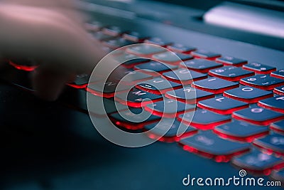 Typing fast on modern red light keyboard Stock Photo