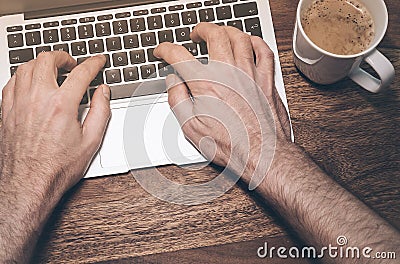 Typing on a laptop computer Stock Photo