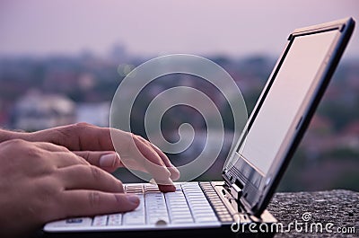 Typing on netbook Stock Photo