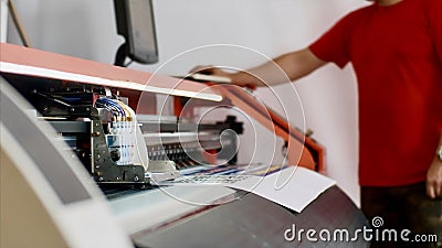 Typography operator is printing production on computerized printing press. Stock Photo