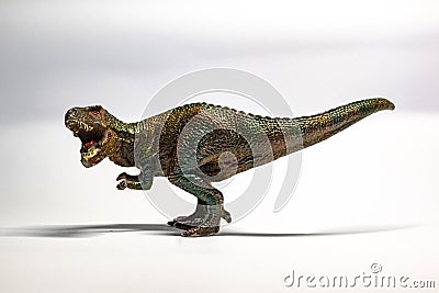 Scary plastic childrens toys T-rex on white background Stock Photo