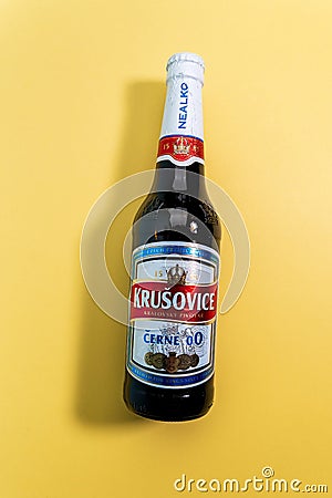 Tyumen, Russia-December 27, 2021: Bottle of dark Krusovice Czech non-alcoholic beer. logo Vertical photo Editorial Stock Photo