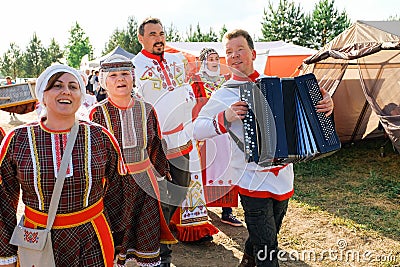 Tyumen, Russia-June 15, 2019. Women And Men In Traditional Costumes Sing With Different Emotions, Play Musical Instruments, At An Editorial Stock Photo