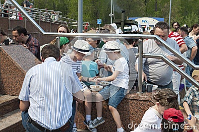 Tyumen, Russia, on May 9, 2019: The field kitchen on the square. People taste soldier`s porridge during the holiday Victory Day Editorial Stock Photo