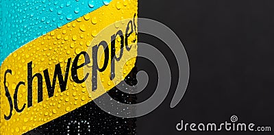 Tyumen, Russia-May 25, 2021: Water drop closeup beside Schweppes tonic water logo. Editorial Stock Photo