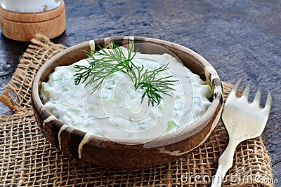 Tzatziki Greek yogurt cucumber sauce in rustic stoneware bowl Stock Photo