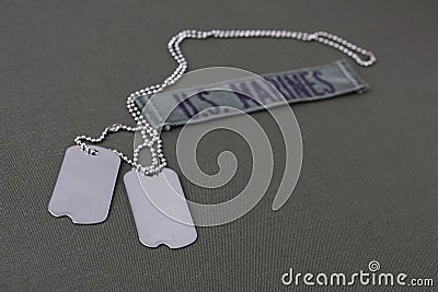 U.S. MARINES Branch Tape with dog tags on olive drab uniform Stock Photo