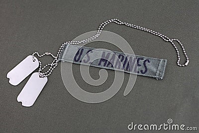 U.S. MARINES Branch Tape with dog tags on olive drab uniform Stock Photo